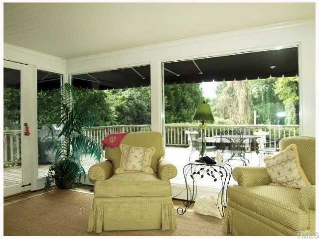 BRIGHT SUNROOM OPENS TO EXTENSIVE BACK DEACK AND OVERLOOKS PRIVATE BACK YARD. Sun Room