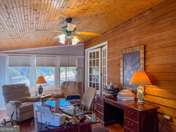 a living room with furniture a chandelier and a window