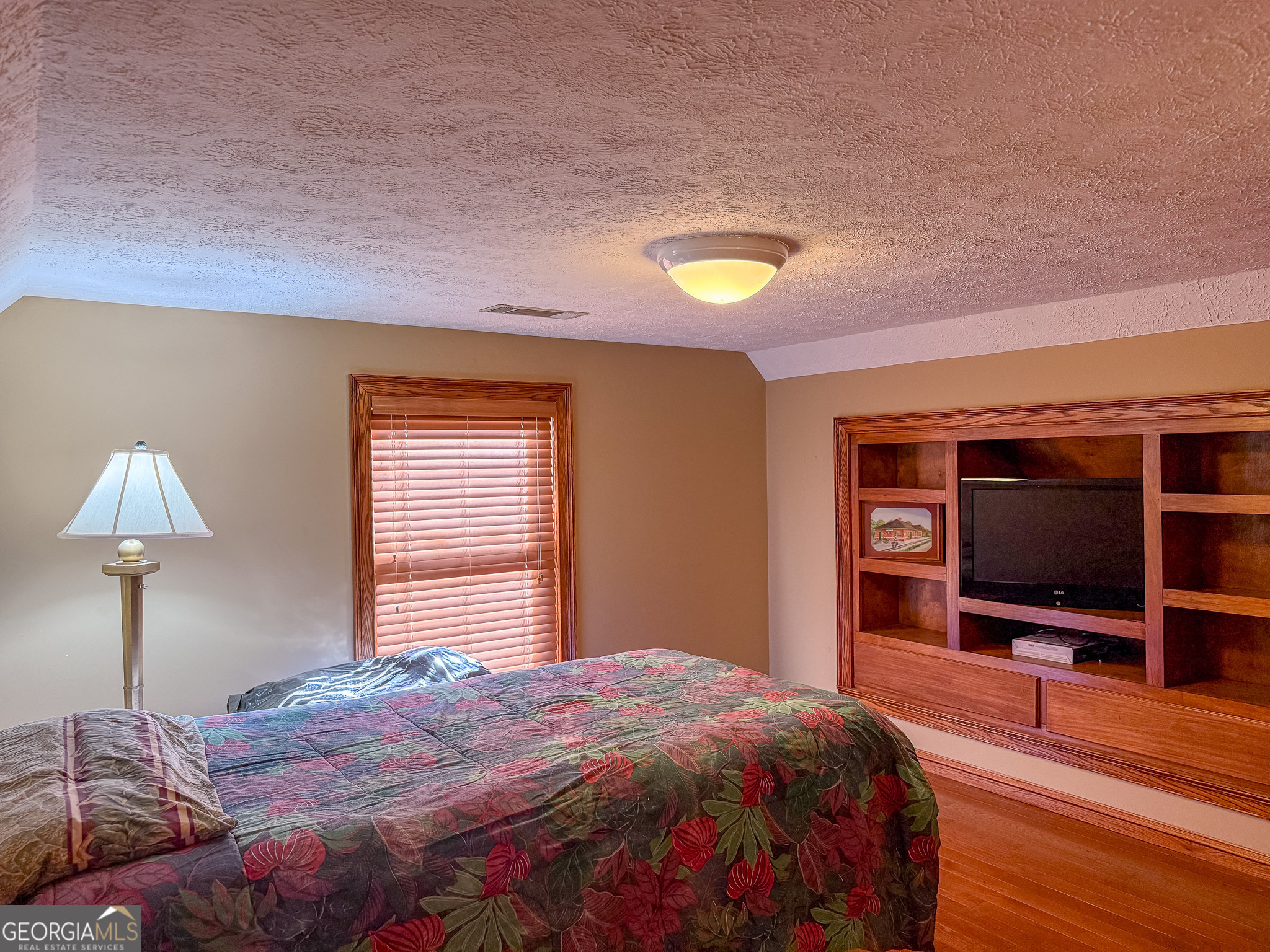 1003 Highway 27 Americus, GA 31709 - Photo 18 of 48 a bedroom with a bed and a flat tv screen on dresser