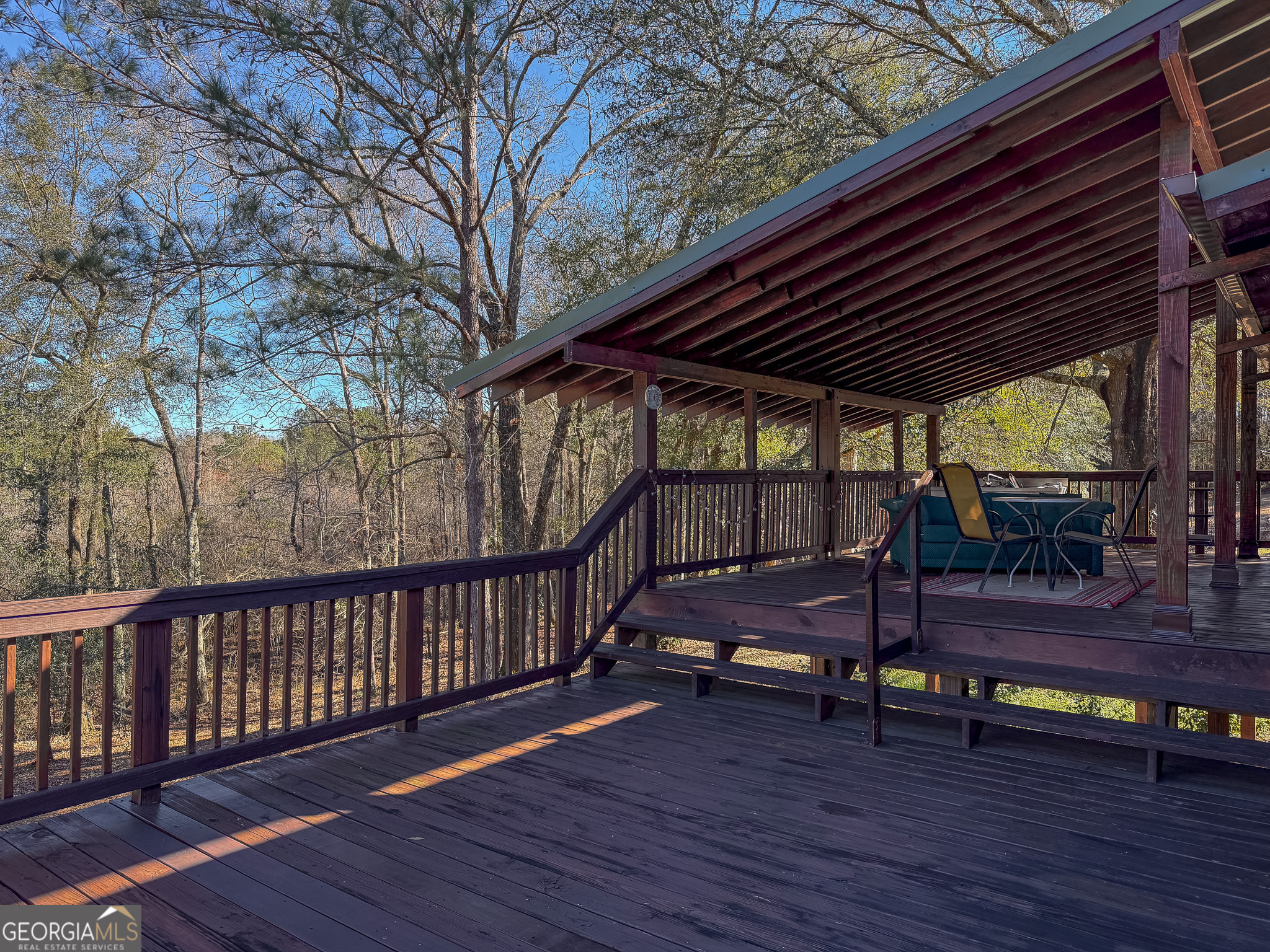 1003 Highway 27 Americus, GA 31709 - Photo 22 of 35 a view of a deck with wooden floor and outdoor seating