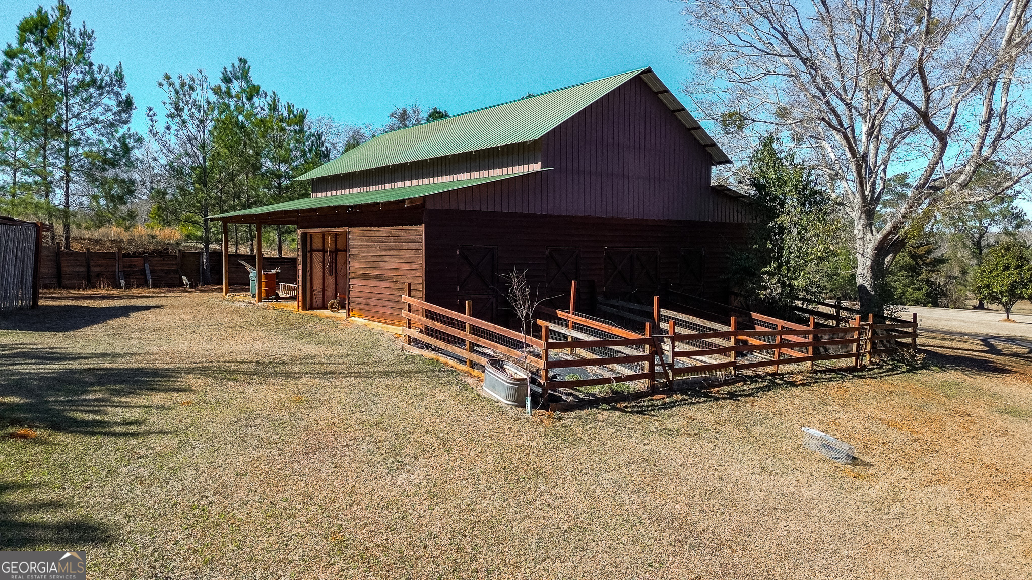 1003 Highway 27 Americus, GA 31709 - Photo 25 of 35 a backyard of a house with barbeque oven and trees