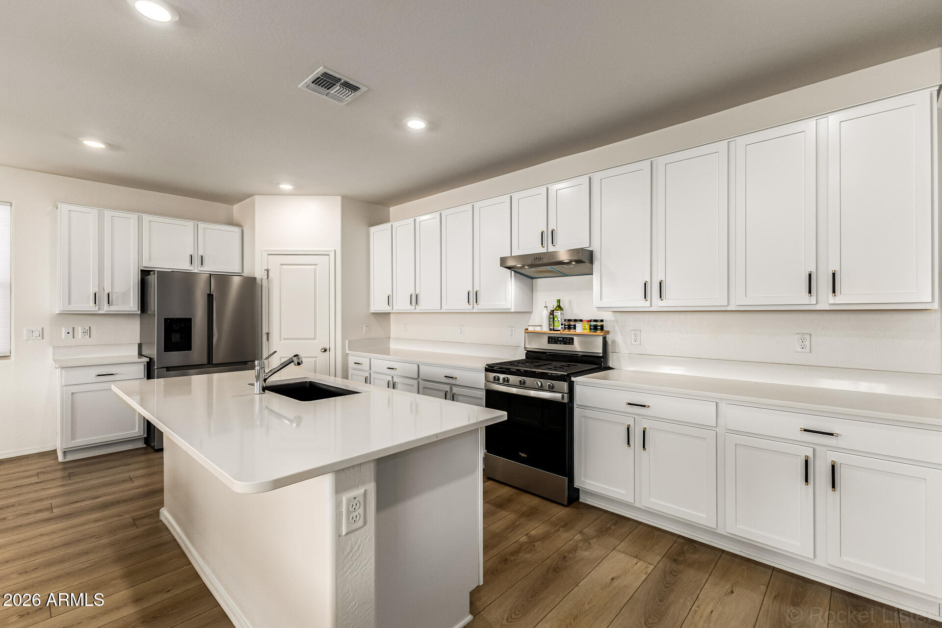 3022 West Estes Way Laveen, AZ 85339 - Photo 13 of 37 a kitchen with white cabinets and stainless steel appliances
