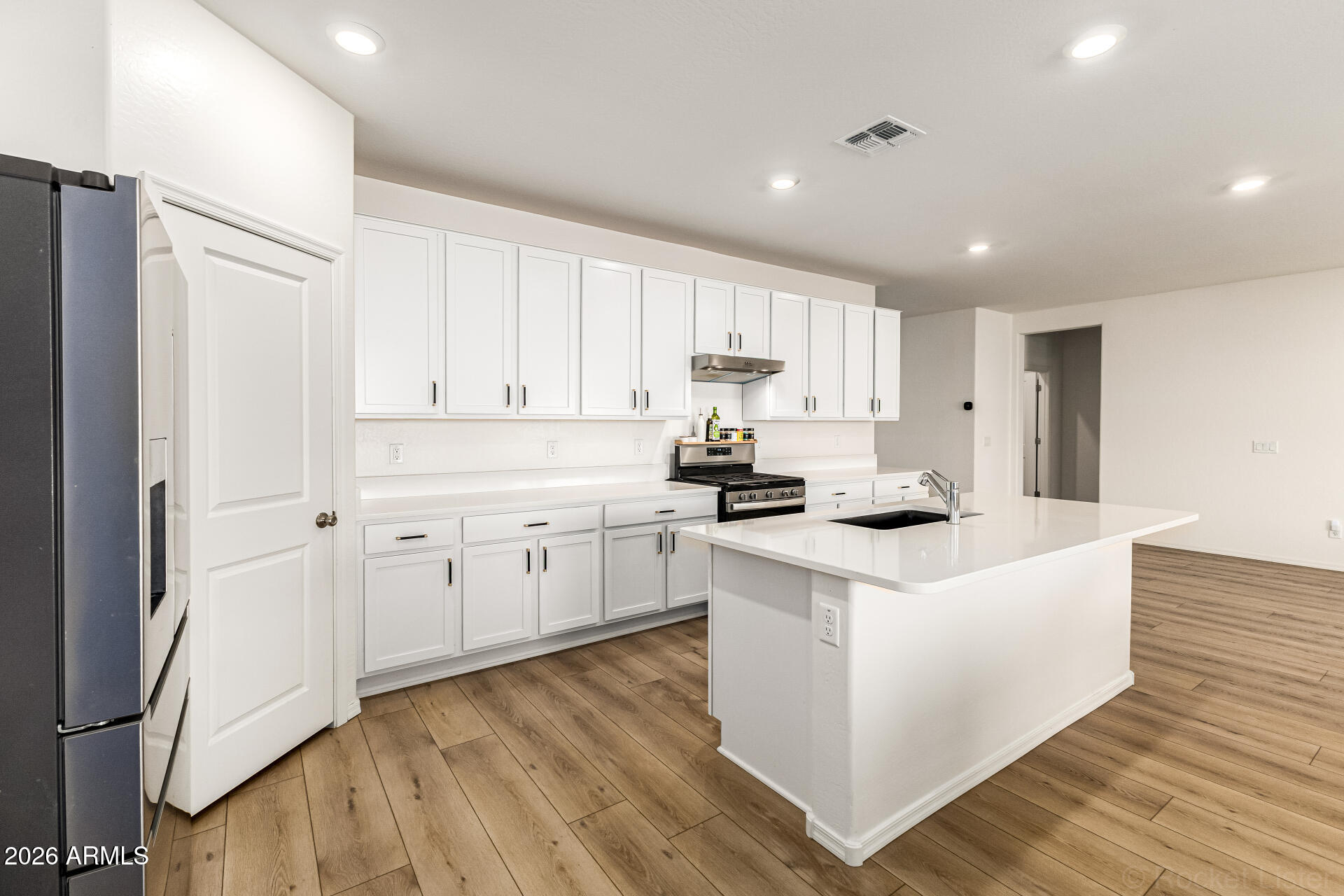 3022 West Estes Way Laveen, AZ 85339 - Photo 14 of 37 a kitchen with cabinets appliances wooden floor and a window