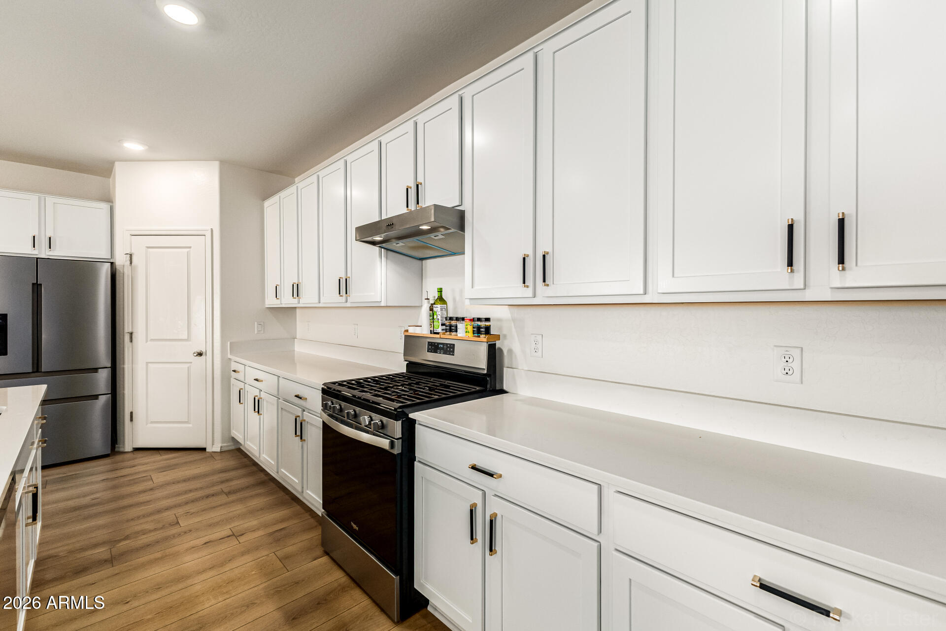 3022 West Estes Way Laveen, AZ 85339 - Photo 18 of 37 a kitchen with granite countertop white cabinets and stainless steel appliances