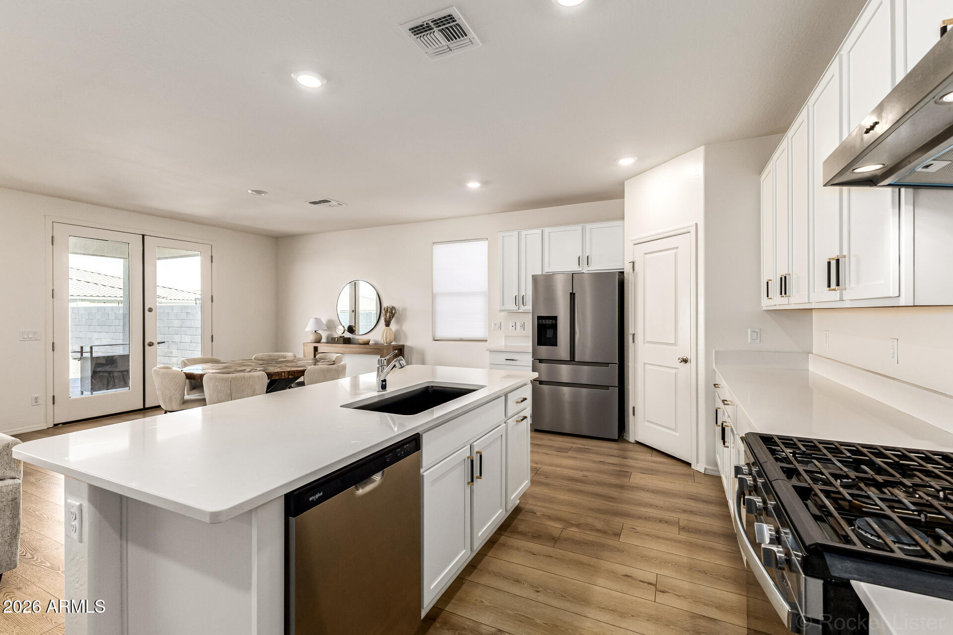 3022 West Estes Way Laveen, AZ 85339 - Photo 19 of 37 a kitchen with stainless steel appliances granite countertop a sink stove and refrigerator