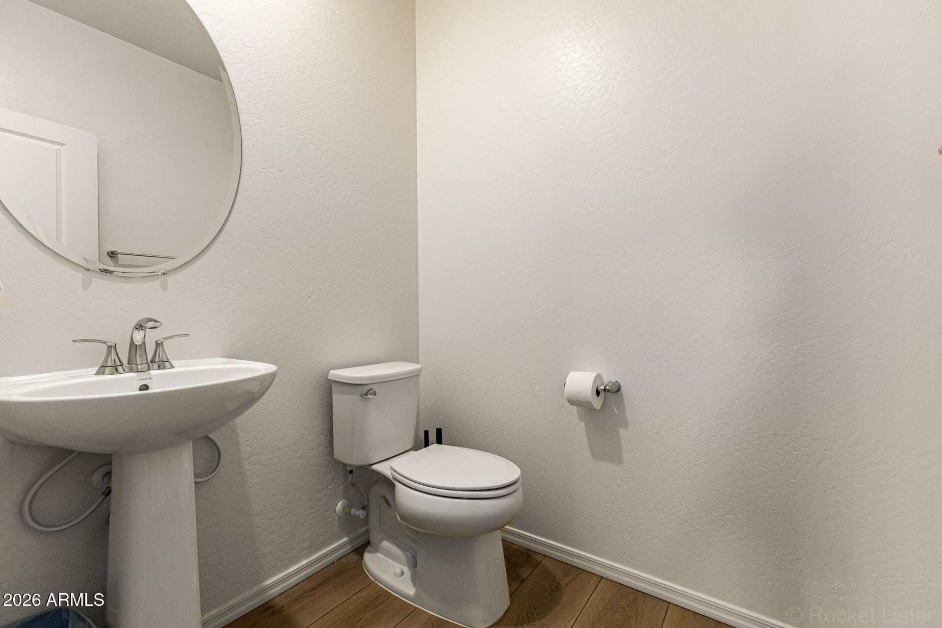 3022 West Estes Way Laveen, AZ 85339 - Photo 20 of 37 a bathroom with a sink a toilet and a mirror