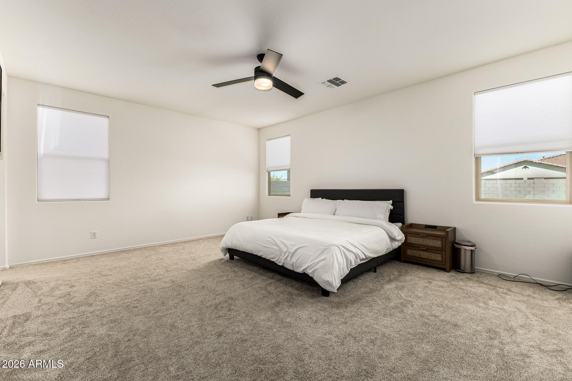 3022 West Estes Way Laveen, AZ 85339 - Photo 21 of 37 a spacious bedroom with a bed and a cabinets