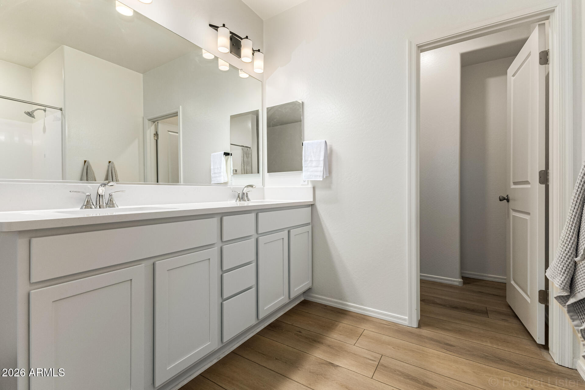 3022 West Estes Way Laveen, AZ 85339 - Photo 24 of 37 a spacious bathroom with a double vanity sink a mirror and a shower