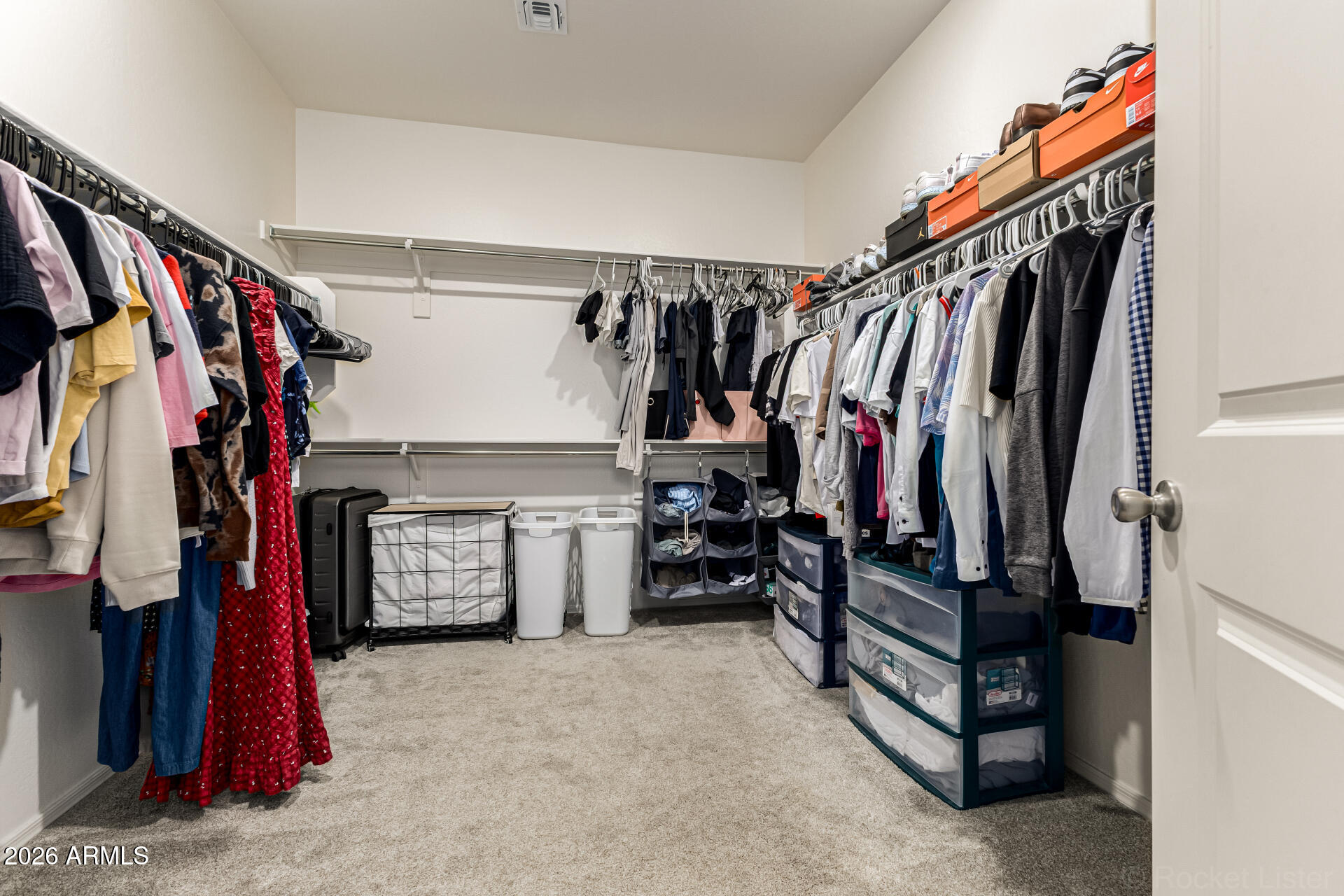 3022 West Estes Way Laveen, AZ 85339 - Photo 25 of 37 a view of walk in closet with clothes
