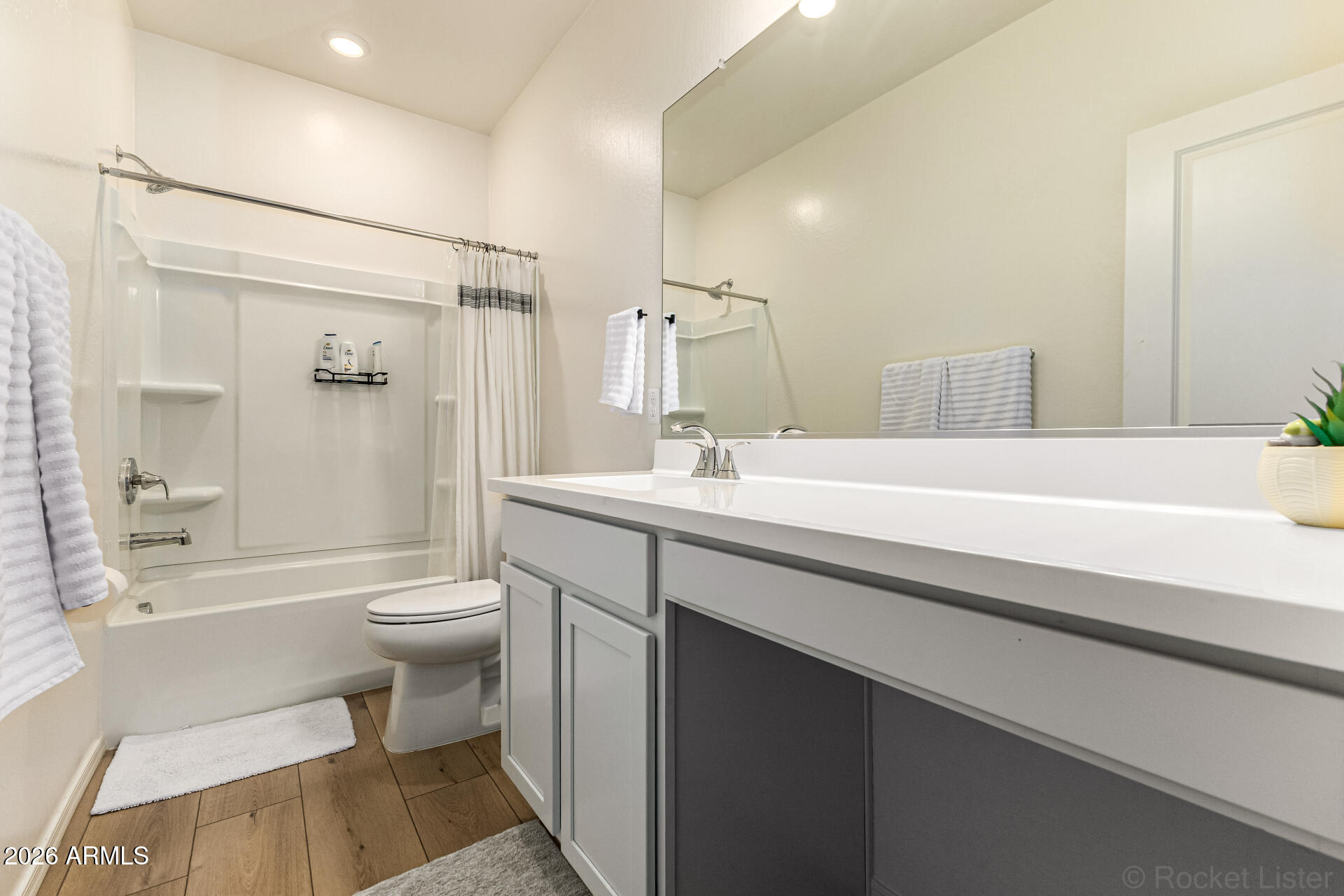 3022 West Estes Way Laveen, AZ 85339 - Photo 29 of 37 a bathroom with a sink a toilet a mirror and shower