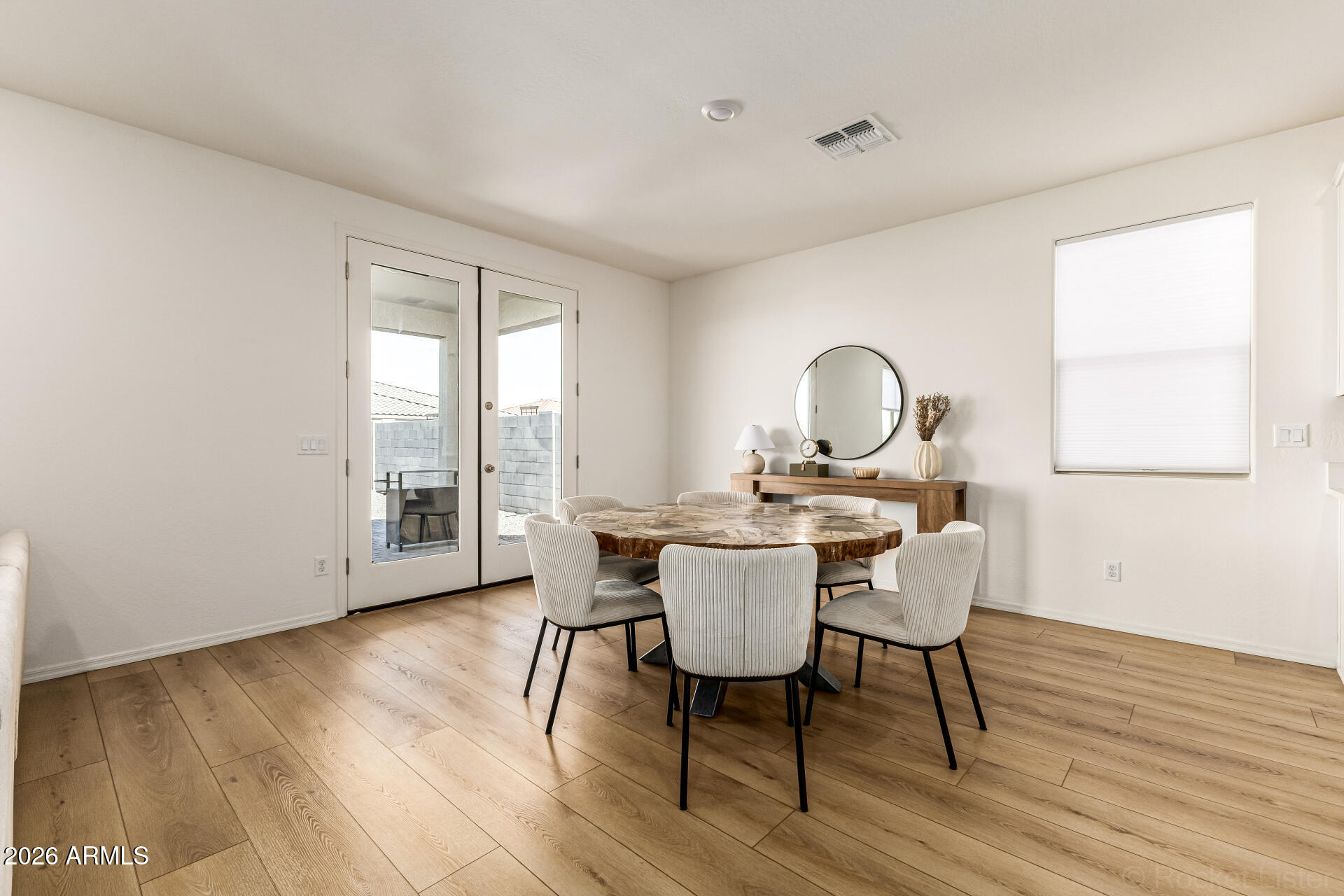 3022 West Estes Way Laveen, AZ 85339 - Photo 10 of 37 a view of a dining room with furniture window and wooden floor