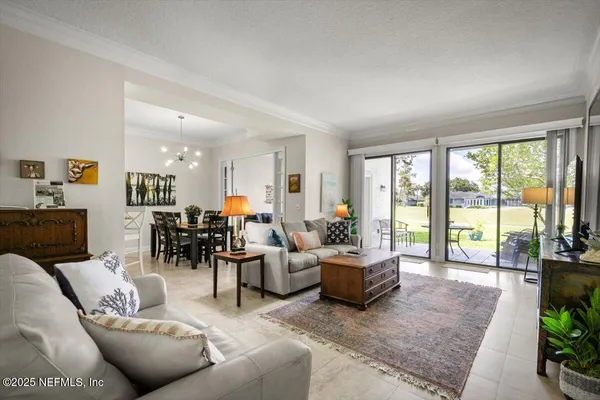 a living room with furniture and large windows