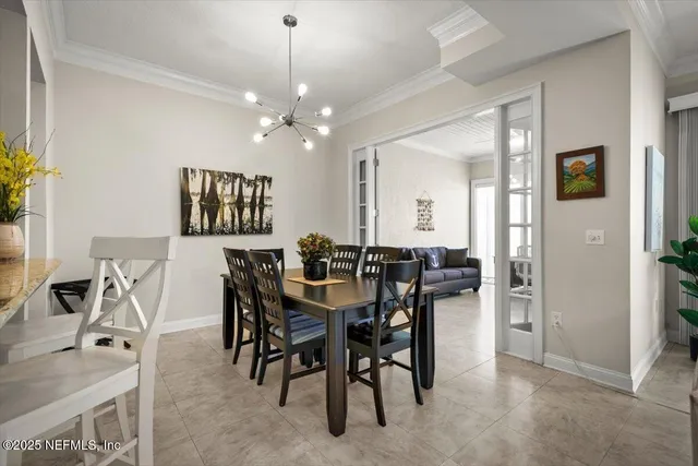 a view of a dining room with furniture and chandelier