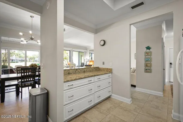 a bathroom with a granite countertop sink a mirror and shower