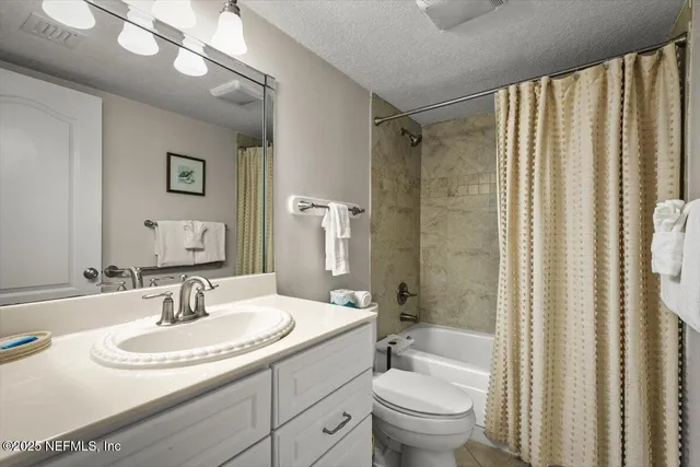 a bathroom with a granite countertop sink toilet a large mirror and shower