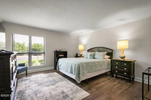 a bedroom with a bed a table and window