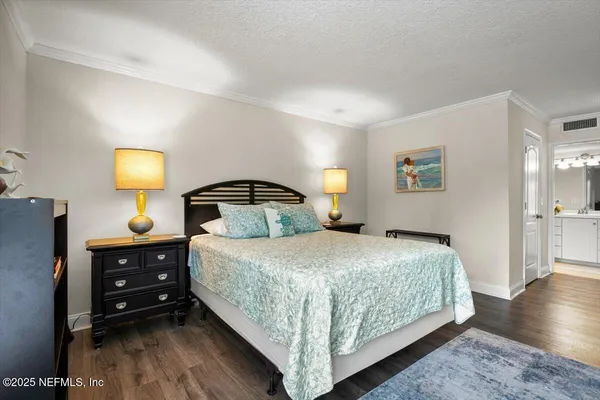 a bedroom with a bed and a lamp