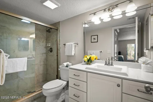 a bathroom with a toilet sink and shower