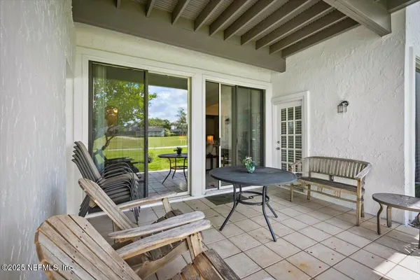 a building outdoor space with patio furniture and glass windows
