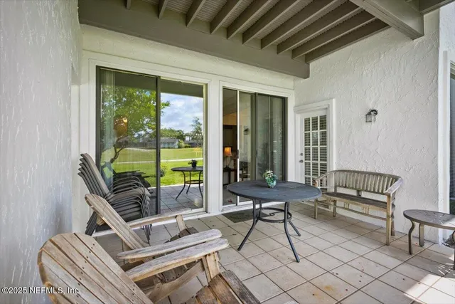 a building outdoor space with patio furniture and glass windows
