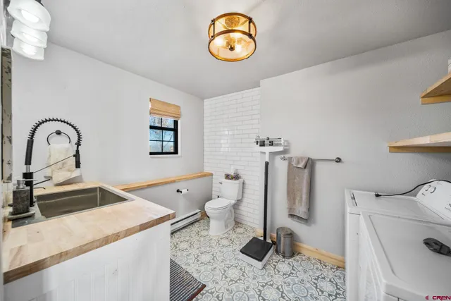 a bathroom with a sink toilet and a mirror