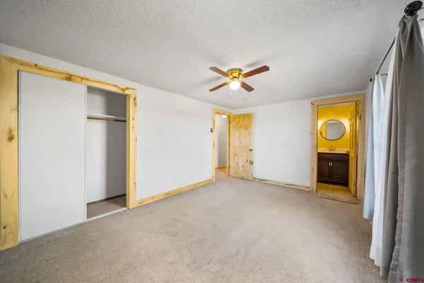 an empty room with a window and closet