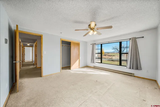a view of a livingroom with a ceiling fan and window