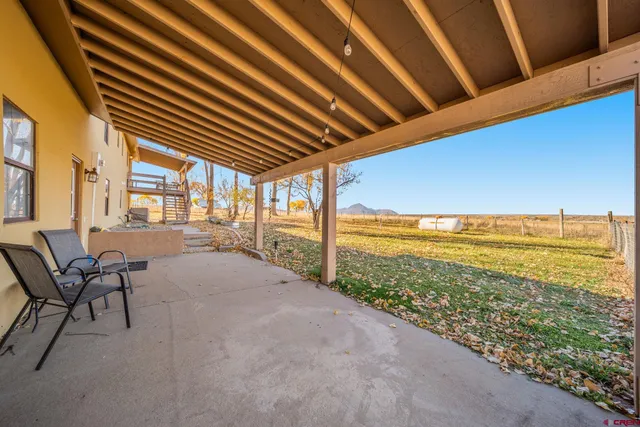 a view of a room with furniture and a floor to ceiling window