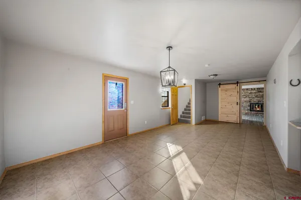 an empty room with entrance and windows
