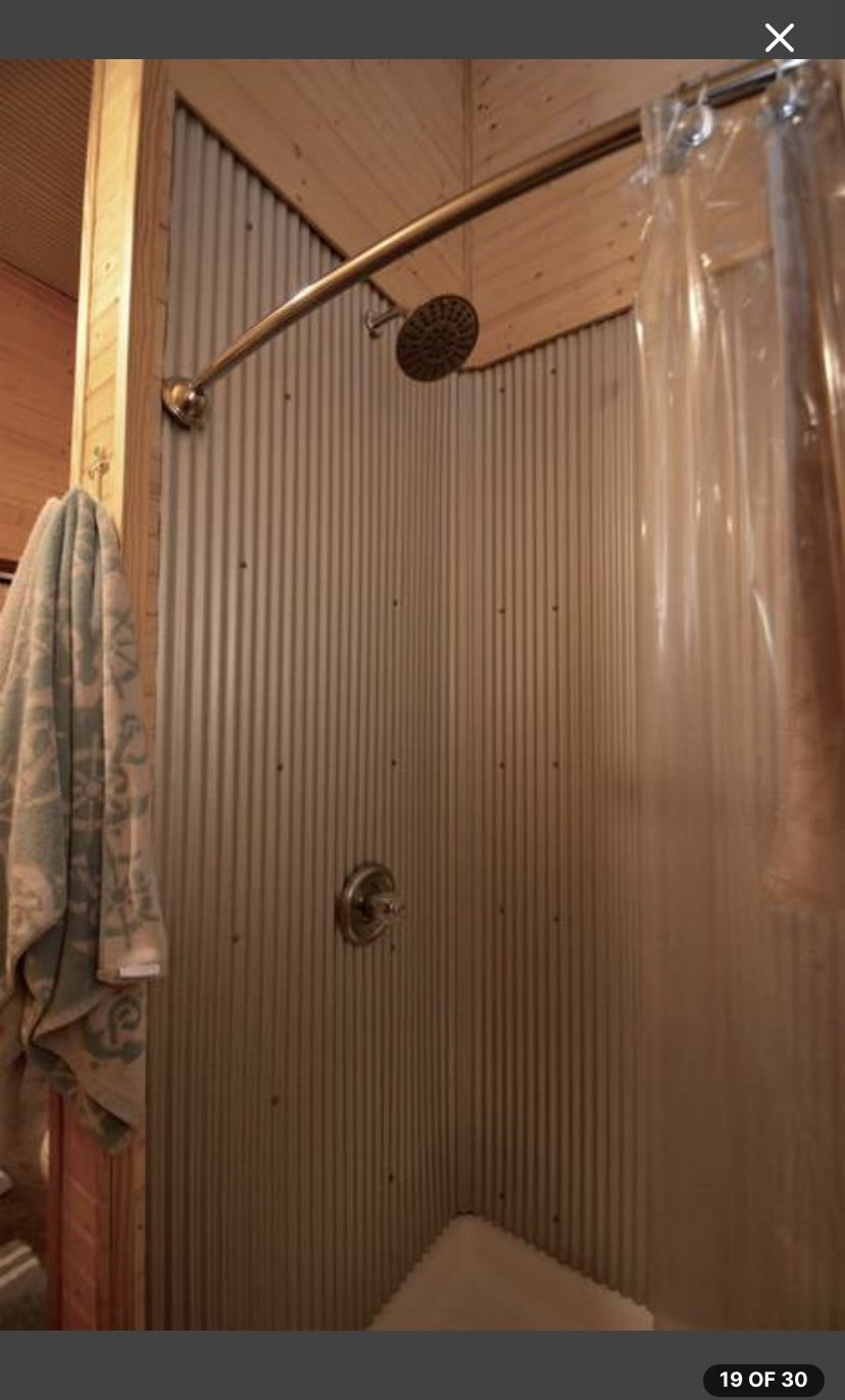 5013 Eva Road Camden, TN 38320 - Photo 11 of 37 a bathroom with a shower curtain and a sink