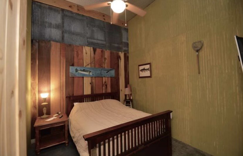 5013 Eva Road Camden, TN 38320 - Photo 12 of 37 a bedroom with a bed and a chandelier