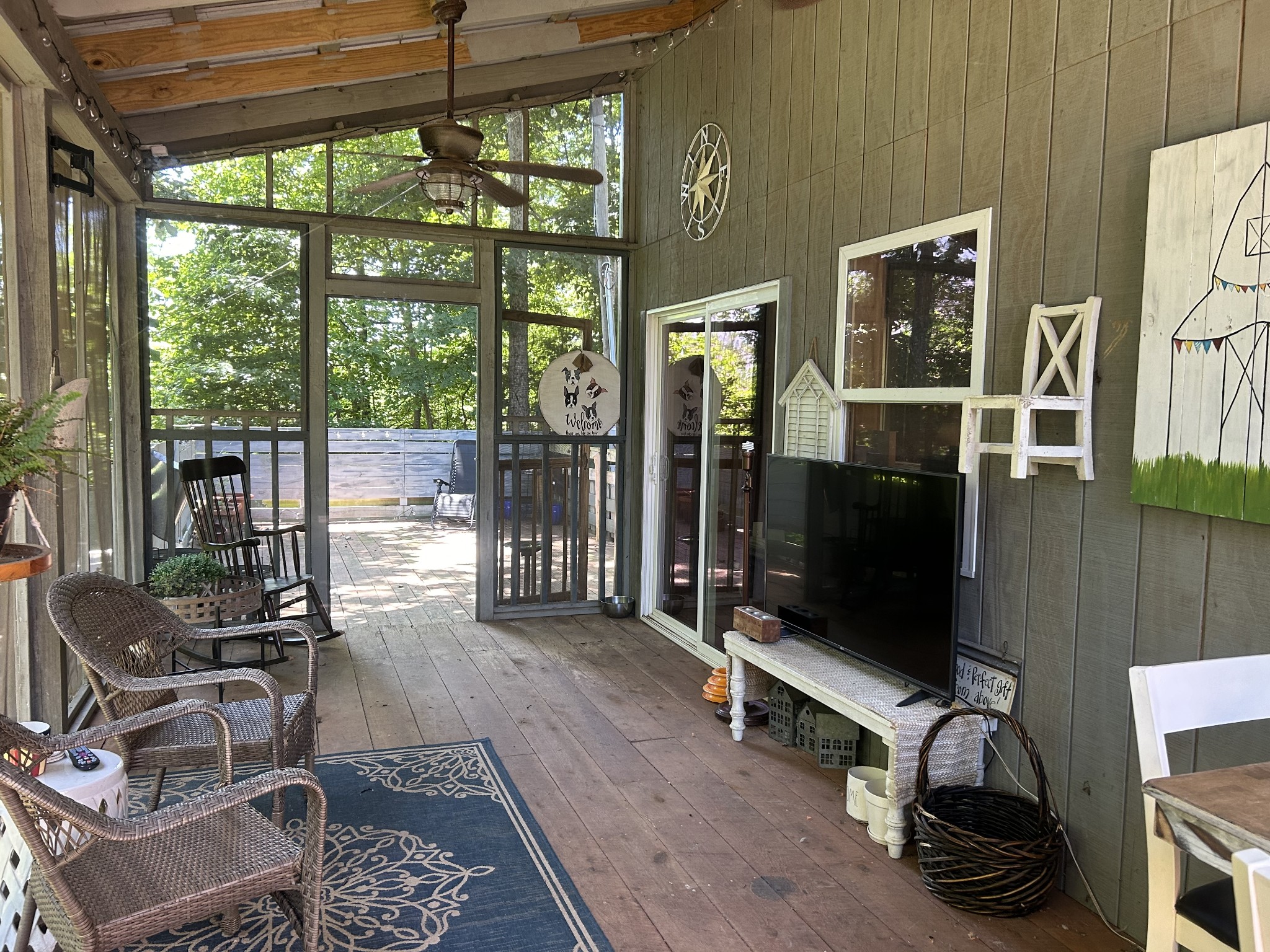 5013 Eva Road Camden, TN 38320 - Photo 15 of 37 a living room with furniture a flat screen tv and floor to ceiling window
