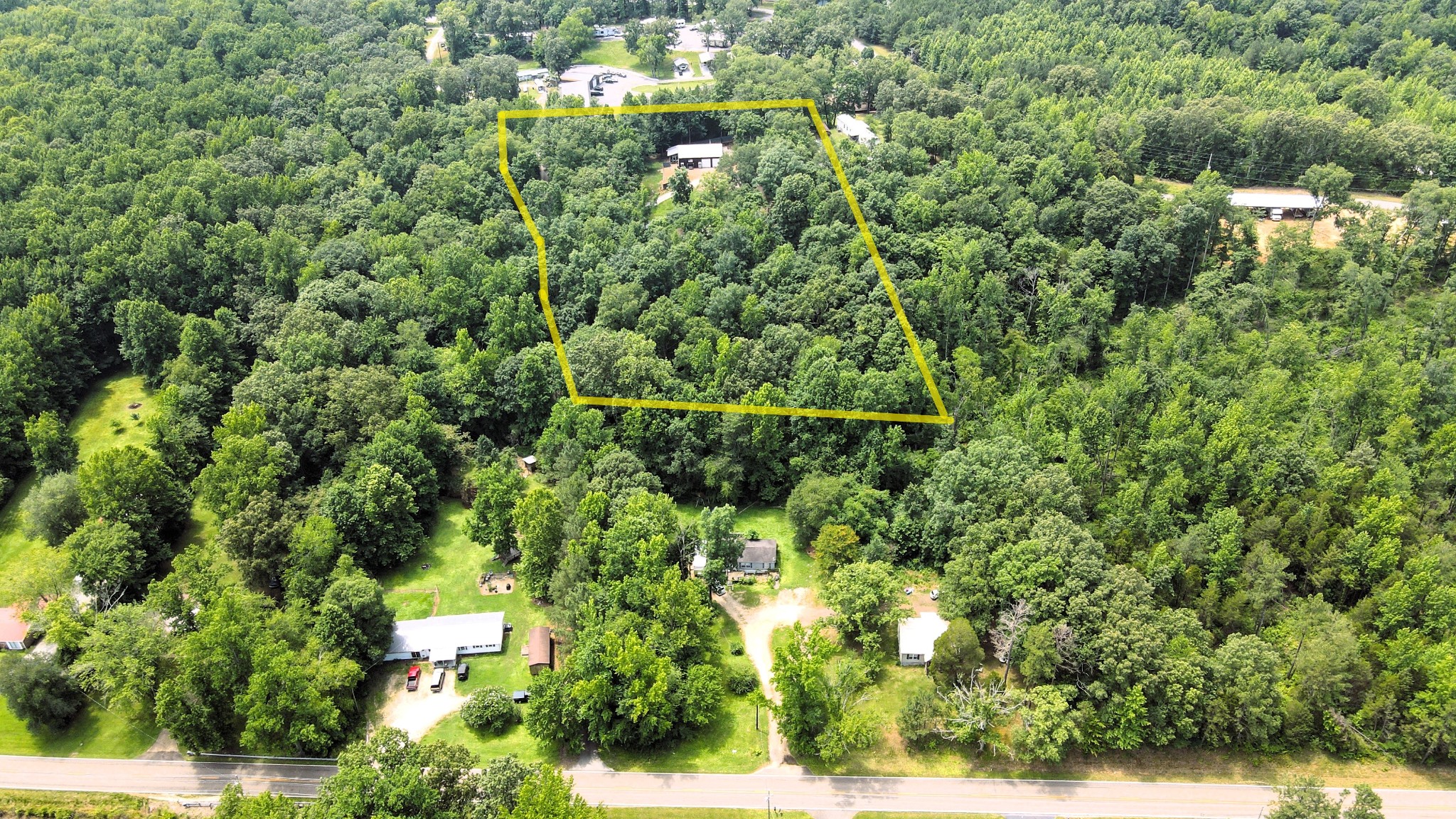 5013 Eva Road Camden, TN 38320 - Photo 27 of 37 an aerial view of residential house with outdoor space and trees all around