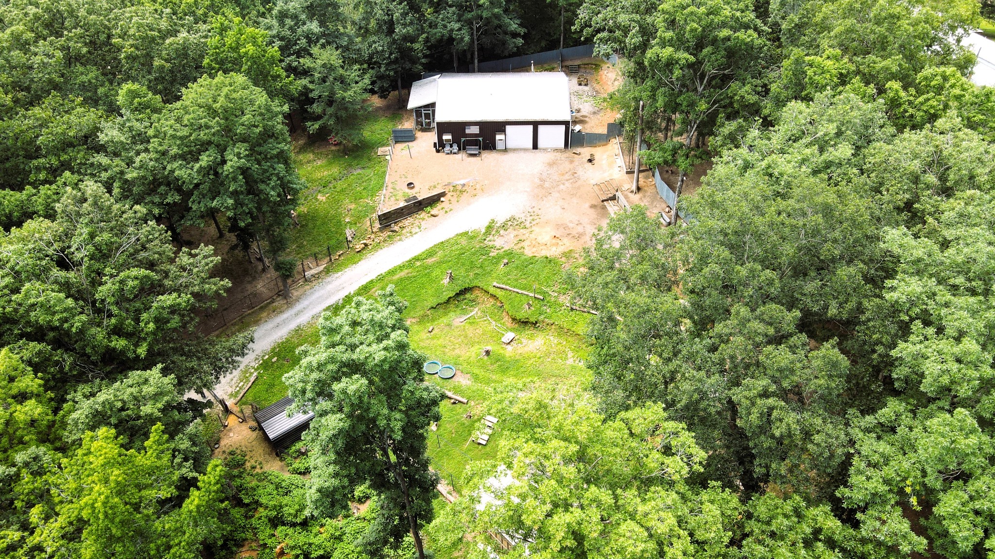 5013 Eva Road Camden, TN 38320 - Photo 33 of 37 a backyard of a house with large trees and plants