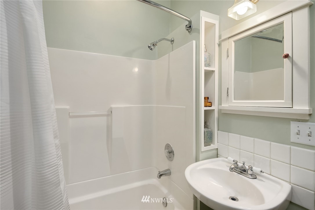 112 North 58th Street Seattle, WA 98103 - Photo 15 of 27 a bathroom with a sink a toilet and shower