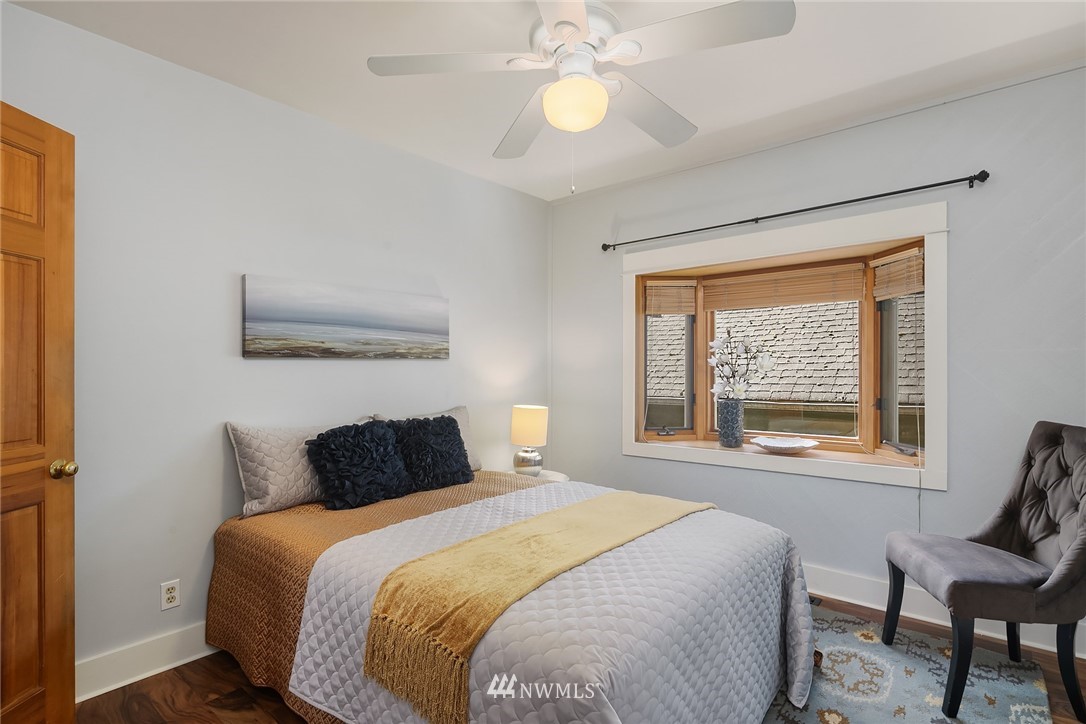 112 North 58th Street Seattle, WA 98103 - Photo 16 of 27 a bedroom with a large bed and a large window