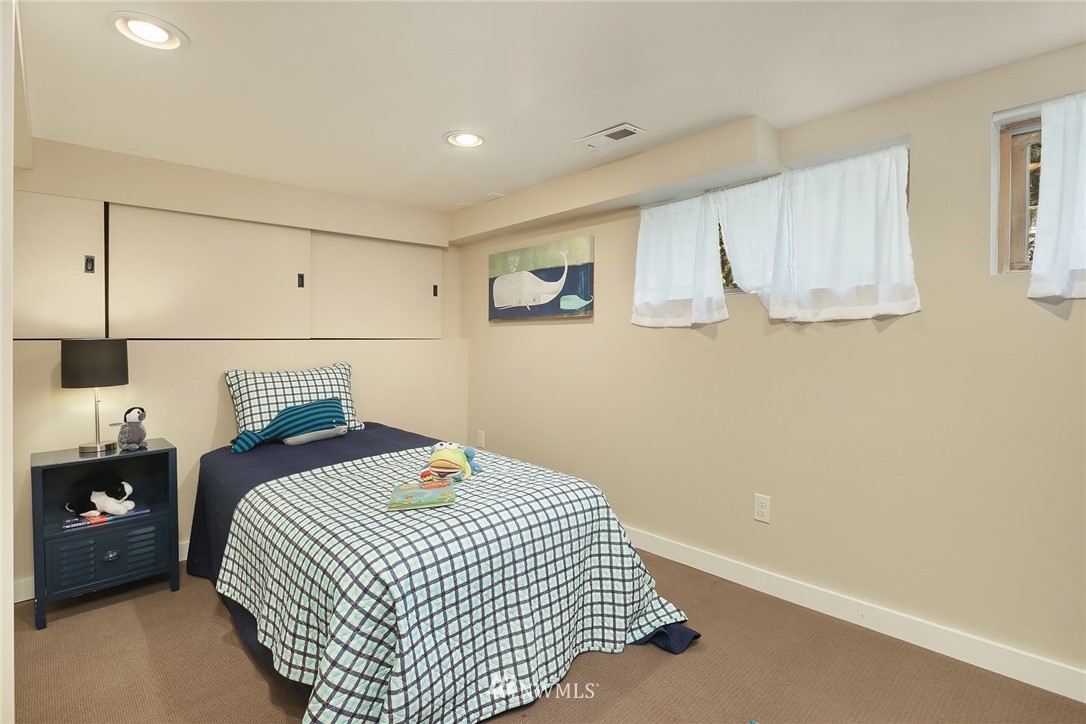 112 North 58th Street Seattle, WA 98103 - Photo 21 of 27 a bedroom with a bed and a window