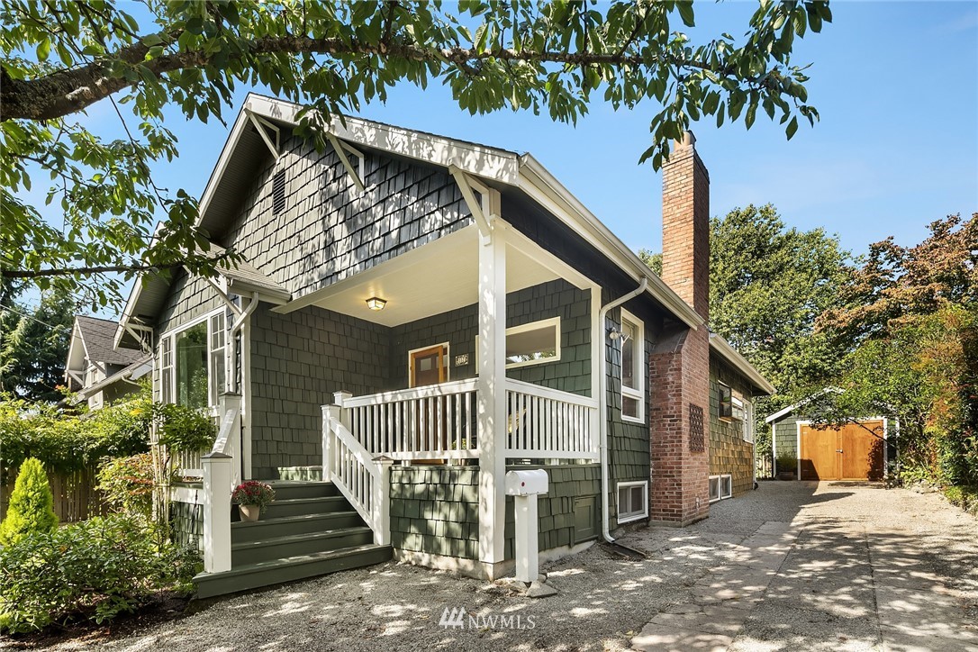 112 North 58th Street Seattle, WA 98103 - Photo 26 of 27 a view of a house with a tree and wooden fence