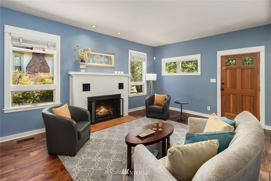 112 North 58th Street Seattle, WA 98103 - Photo 5 of 27 a living room with furniture a large window and a fireplace