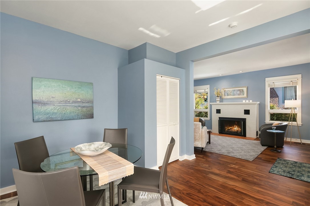 112 North 58th Street Seattle, WA 98103 - Photo 7 of 27 a living room with furniture a fireplace and a table