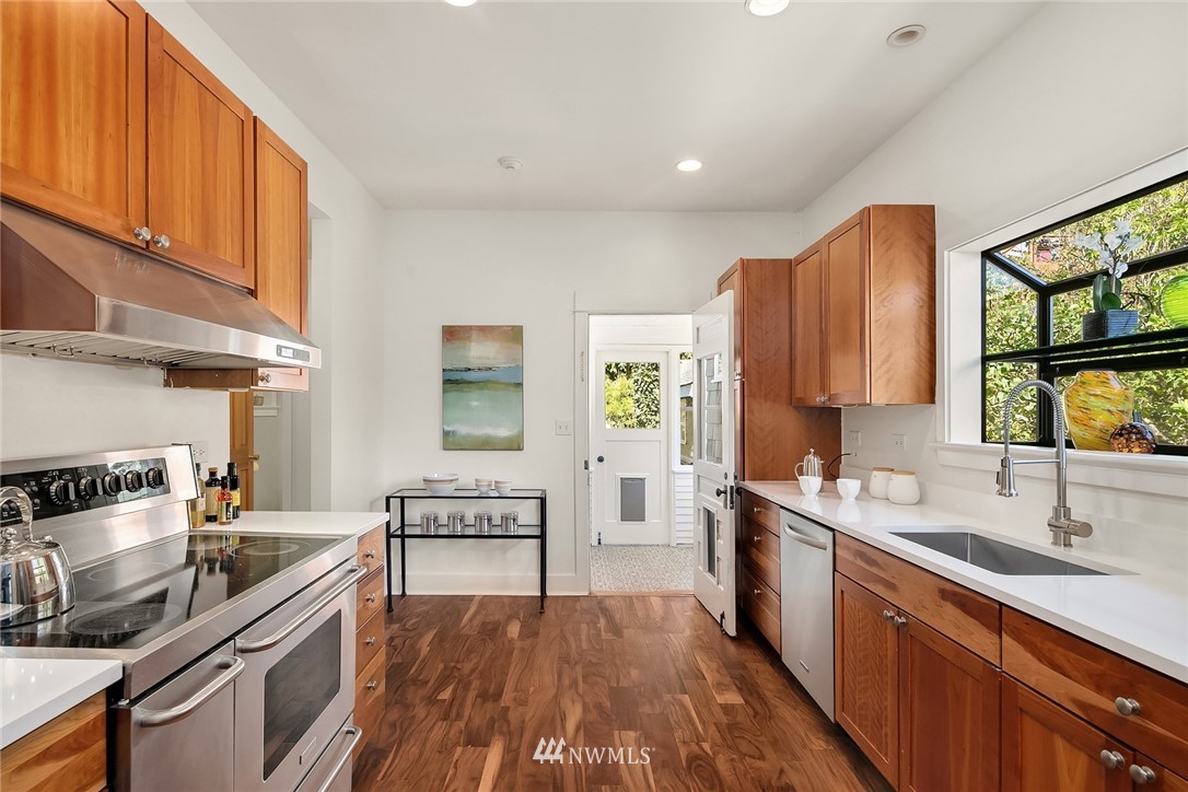 112 North 58th Street Seattle, WA 98103 - Photo 10 of 27 a kitchen with a sink stove and cabinets