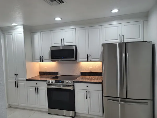 a kitchen with a refrigerator stove and microwave