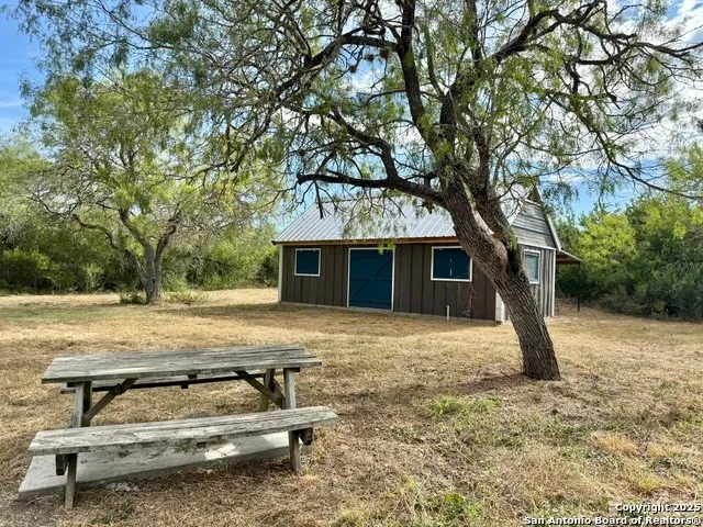a view of a house with backyard space and sitting area