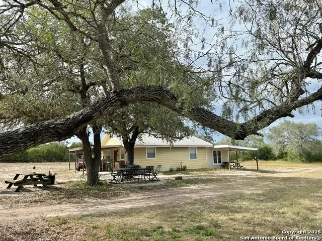 a living room with furniture and large windows