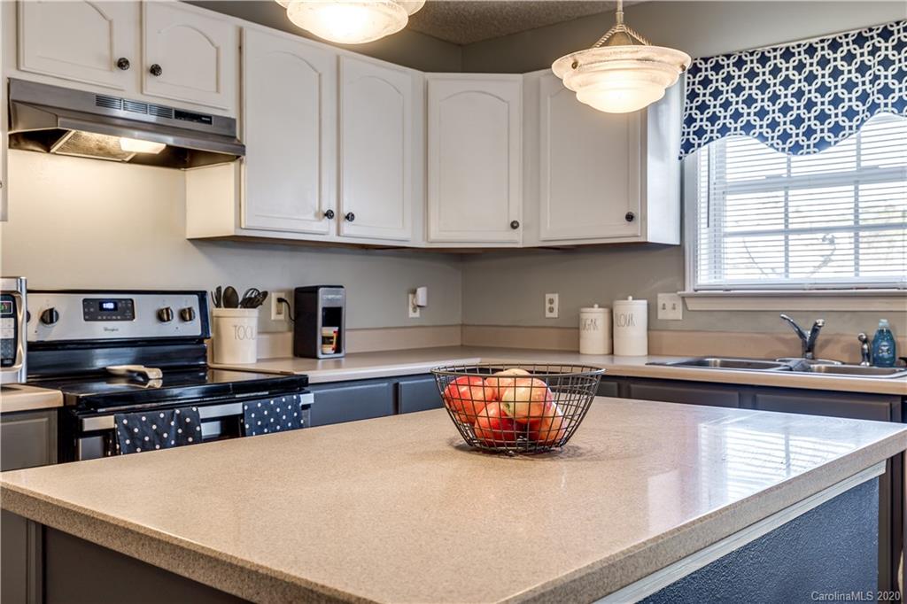 8808 Old Potters Road Charlotte, NC 28269 - Photo 13 of 34 a kitchen with granite countertop a sink a stove and cabinets