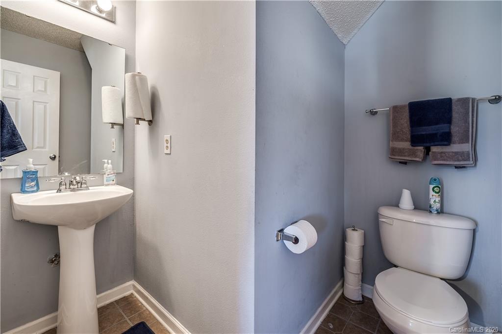 8808 Old Potters Road Charlotte, NC 28269 - Photo 17 of 34 a bathroom with a toilet sink and mirror