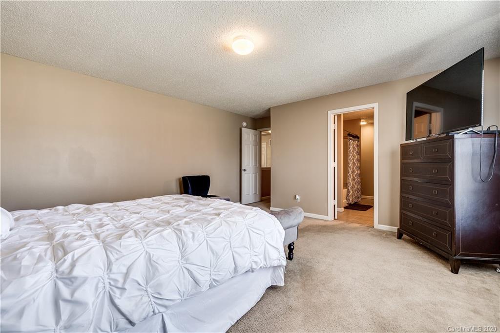 8808 Old Potters Road Charlotte, NC 28269 - Photo 20 of 34 a bedroom with a bed and a television