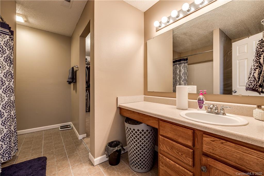 8808 Old Potters Road Charlotte, NC 28269 - Photo 22 of 34 a bathroom with a sink and a mirror
