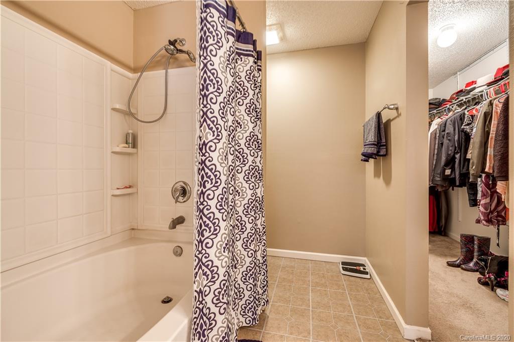 8808 Old Potters Road Charlotte, NC 28269 - Photo 23 of 34 a bathroom with a bathtub and shower