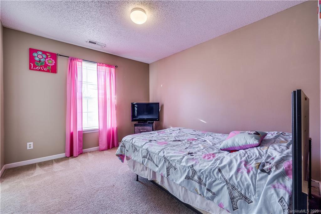 8808 Old Potters Road Charlotte, NC 28269 - Photo 25 of 34 a bedroom with a bed and a window